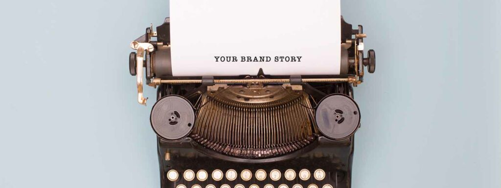 Typewriter with paper that has "Your Brand Story" typed on it.
