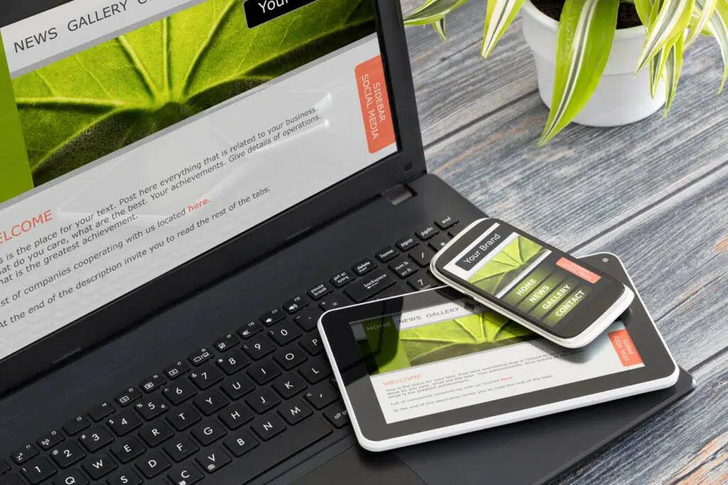 Laptop, tablet and phone showing desktop and mobile versions of a website.