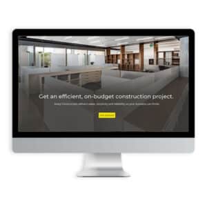 An image of a computer on a white background with Avery Construction's website shown on the screen.